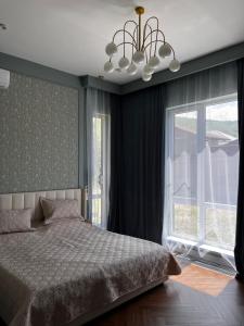 a bedroom with a bed and a large window at LouLou Hills in Uchastkovoyye Khozyaystvo SKhI +22 photos