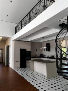 a kitchen with a staircase in the middle of a room at LouLou Hills in Uchastkovoyye Khozyaystvo SKhI