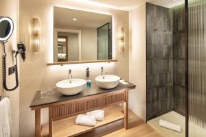 a bathroom with two sinks and a shower at Esencia de Fuerteventura by Princess in Playa Jandia +32 photos