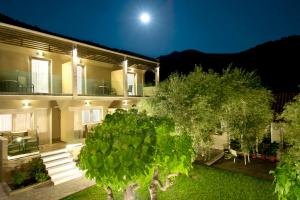 a house with a tree in front of it at Louloudis Fresh-Adults Only in Skala Rachoniou
