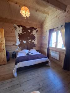 a bedroom with a bed in a wooden cabin at Les Bruchels in Longechaux