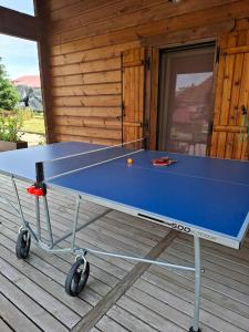 a ping pong table sitting on a deck at Les Bruchels in Longechaux