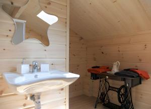 a bathroom with a sink in a wooden cabin at Les Bruchels in Longechaux +19 photos