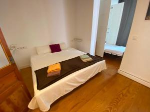 a bedroom with a bed with two towels on it at Calle Villarroel Barcelona 3-2 in Barcelona