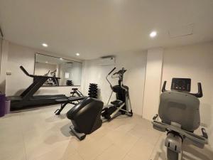 a gym with two exercise bikes and a mirror at The Guest Hotel & Hostel in Chiang Mai +198 photos