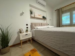a bedroom with a bed and a table with a plant at Garden Guest Room in Fanari
