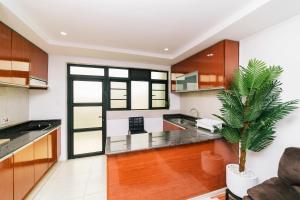 a kitchen with a palm tree in the middle of it at Highlands Suites Hotel and Apartments in Kigali +11 photos