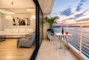 a living room with a view of the water at ICONIC SALONICA SUITES seafront in Thessaloniki