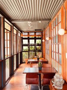 a room with tables and chairs and windows at The Lark Inn & Kitchen in San Juan