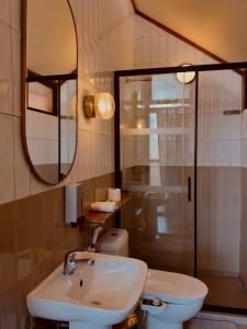 a bathroom with a sink and a toilet and a mirror at The Lark Inn & Kitchen in San Juan +25 photos