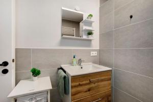a small bathroom with a sink and a toilet at Ferienwohnung am Alenberg in Münsingen