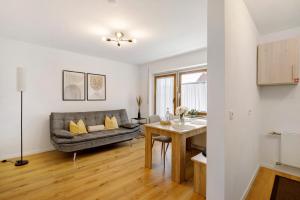 a living room with a couch and a table at Ferienwohnung am Alenberg in Münsingen +22 photos