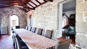 a dining room with a long table and chairs at La Casona Imperial 2 in Galapagar