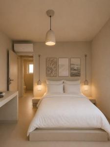 a bedroom with a large white bed and two lights at Doto Villa with private pool in Agia Effimia +40 photos