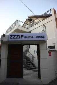 a zzhp guest house with a garage and a staircase at Zzzip Guesthouse in Hongdae in Seoul