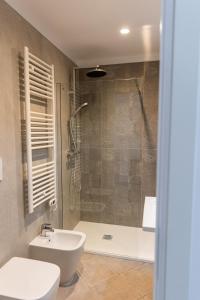 a bathroom with a shower and a toilet and a sink at Casa Bottega in San Salvo
