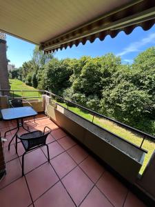 a patio with a table and chairs on a balcony at Apartment Grenzland in Herzogenrath