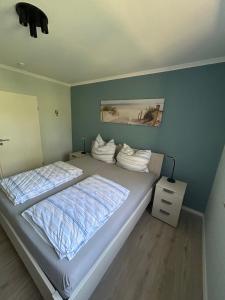 a bedroom with two beds and a blue wall at Apartment Grenzland in Herzogenrath