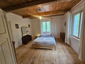 a bedroom with a bed in a room with wooden floors at Leśna Kraina in Międzyrzec Podlaski