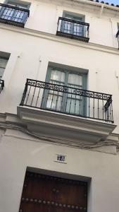 a building with two windows and a white door at Casa Boutique La Pila del Pato in Seville
