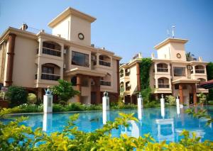 a building with blue water in front of it at Sun City Resort in Calangute