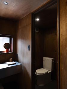 a small bathroom with a toilet and a window at 刷々 sassa in Osaka