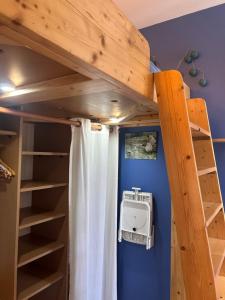 a bunk bed in a room with a ladder at studio 25 in Dinard