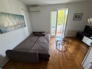a living room with a couch and a television at Apartment Biserka in Cavtat