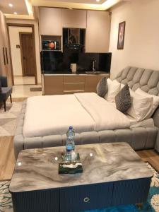 a living room with a bed and a couch at Park Ridge Hotel Serviced Apartments - Executive Apartment in Murree +3 photos