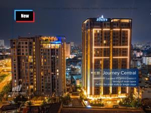 a city skyline with two tall buildings at night at Journey Central - ZENITY & D1 MENSION in Ho Chi Minh City