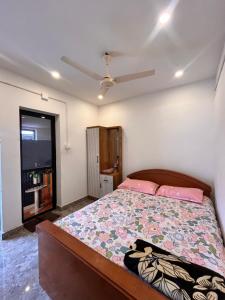 a bedroom with a bed and a ceiling fan at Kp's Riverland Resorts in Madwa