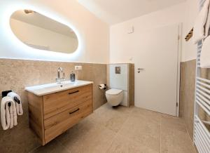 a bathroom with a sink and a toilet at HabeDere Apartments Allgäu in Obergünzburg +25 photos