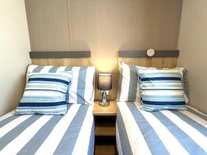 two beds sitting next to each other in a bedroom at Gordy's Nook in Scarborough