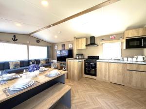 a kitchen and living room with a table and a couch at Gordy's Nook in Scarborough +17 photos