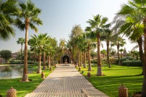 a walkway lined with palm trees in a park at SOL by Meliá Oasis Marrakech - All Inclusive in Marrakesh
