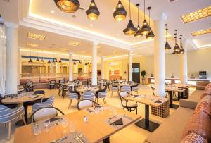 a restaurant with tables and chairs at SOL by Meliá Oasis Marrakech - All Inclusive in Marrakesh +54 photos