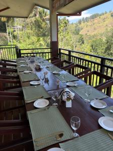 a long table with plates and wine glasses on it at Mount Rivera in Atabage Pallegama