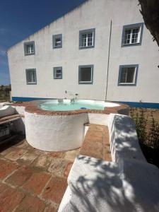 a building with a sink in front of a building at Herdade Monte da Tapada in Alqueva