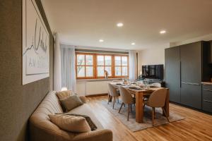 a living room with a couch and a table with chairs at Urlaub am Schafhof in Rimbach