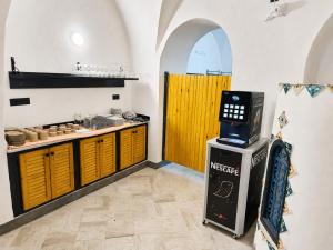 a kitchen with a counter and a machine in a room at Hôtel Medina in Sousse