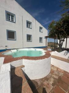 a pool in front of a building at Herdade Monte da Tapada in Alqueva