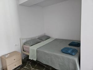 a bedroom with a bed and a nightstand next to it at Ioannis Appartements Glossa in Glossa +13 photos