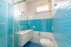 a bathroom with a toilet and a glass shower at CalaDune Villas in Pizzo +9 photos