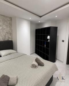 a bedroom with two beds and a black cabinet at ATK apartment in Koper +2 photos