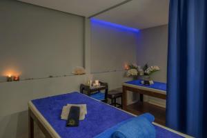 a room with two beds and a blue light at SOL by Meliá Marina Beach Crete in Gouves