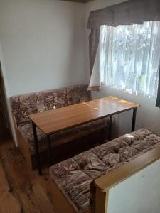 a living room with a table and a couch at Mobile home in Liscannor
