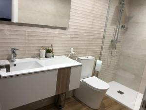 a bathroom with a sink and a toilet and a shower at Entre Micelios in Vinuesa