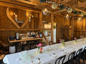 a dining room with a long table with white table cloth at Kachlówka in Lachowice