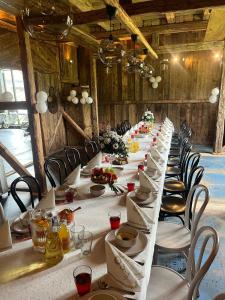 a long table with chairs and plates of food on it at Kachlówka in Lachowice +24 photos