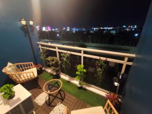 a balcony with a view of a city at night at CA Smart Staycation at Azure North in Lagundi